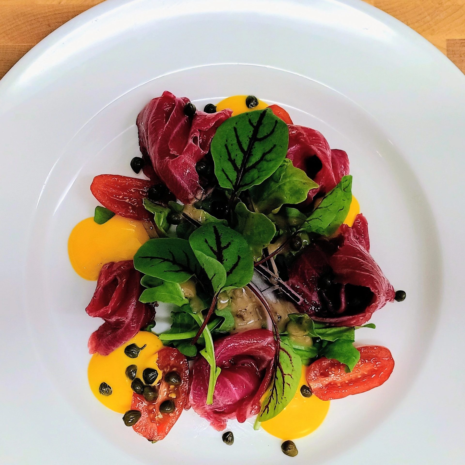 Beet-cured salmon with saffron aioli, capers and red vein sorrel
